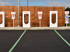 No Parking sign and green pavement markings at Tesla supercharging station